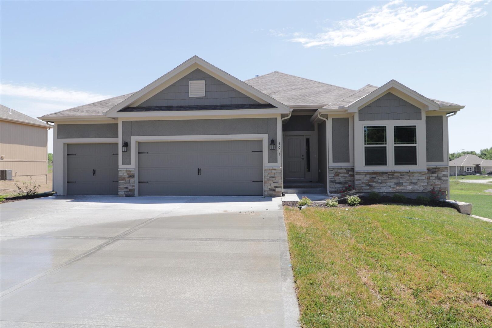 A house with two garage doors and a driveway.