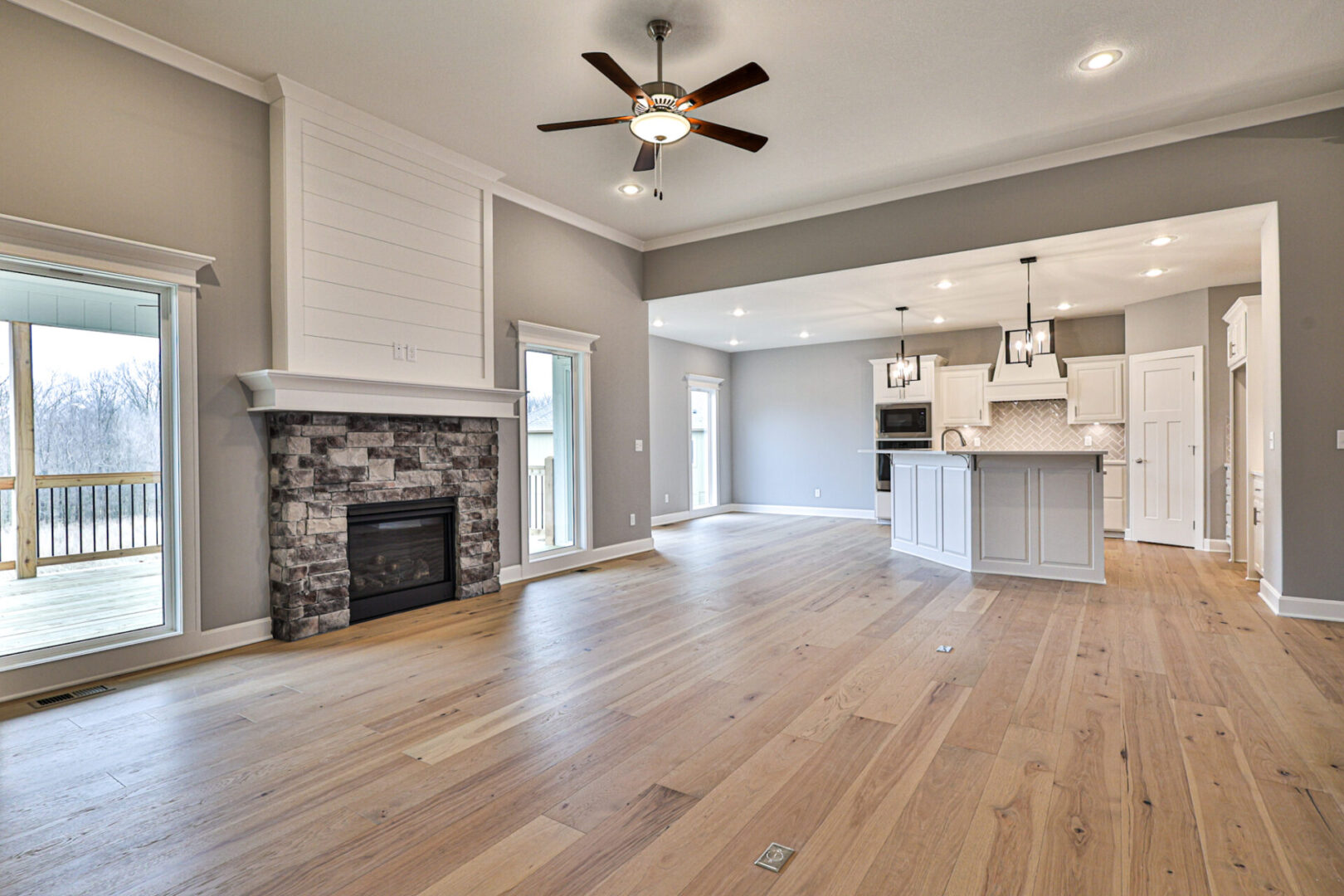 A large open floor plan with a fireplace and kitchen.